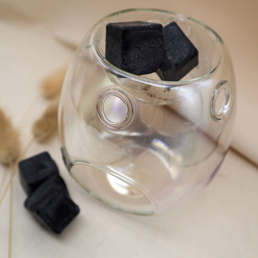 Glass Wax Melt burner is a clear pearl colour with two black melts in the top and two wax melts beside it