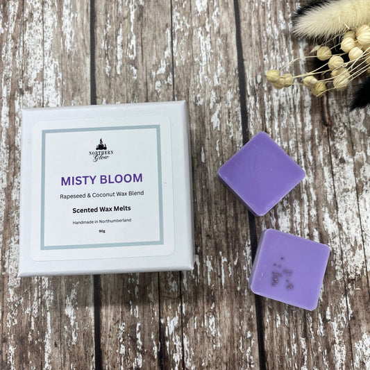 Purple square wax melts inside a white box on a wooden background